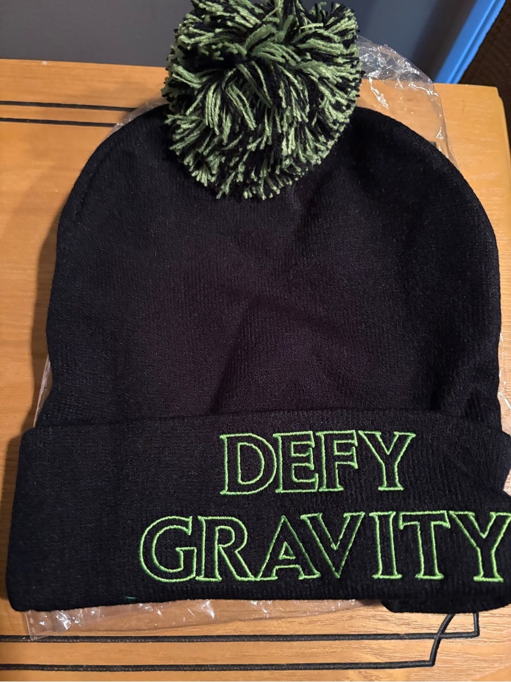 Wicked Black Beanie Hat with Green Pom and 'Defy Gravity' Embroidery